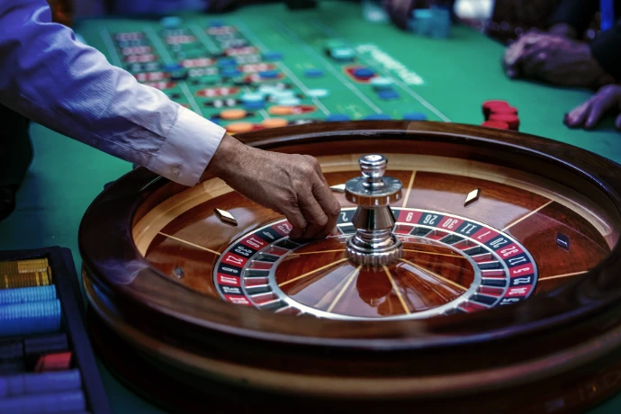a man is playing a game of roule on a green table